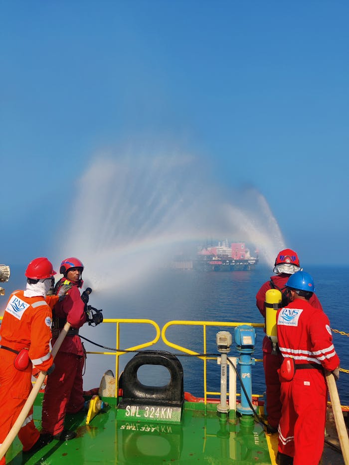 services-04 Seafaring emergency team conducts a drill with fire hoses to simulate rescue operations.