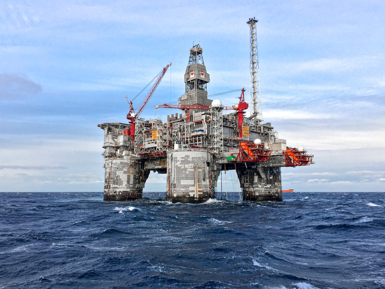 An offshore oil platform in Norway's North Sea under a clear blue sky.